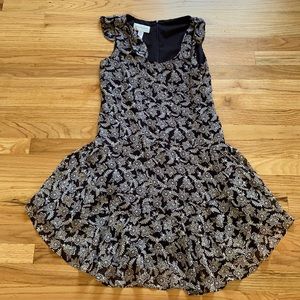 White and black dress with ties at the shoulders.